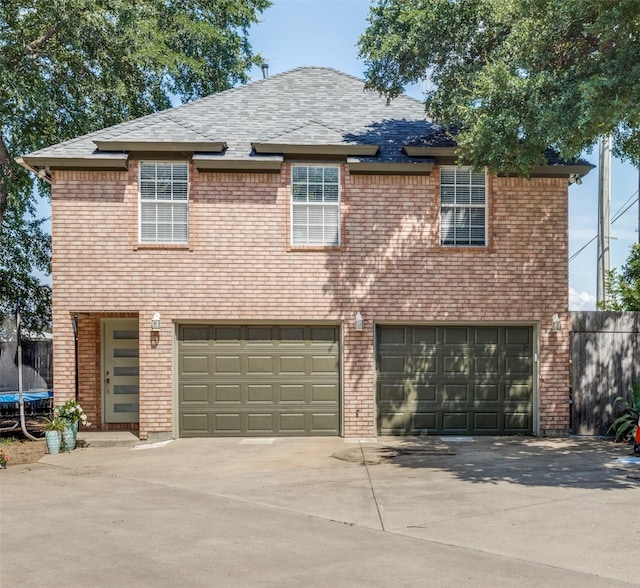 view of front of house featuring a garage and a trampoline