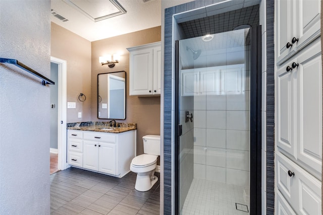 bathroom with vanity, an enclosed shower, tile patterned floors, and toilet