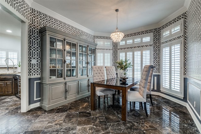 dining space with crown molding and a chandelier