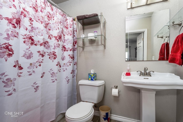 bathroom with sink, toilet, and a shower with curtain