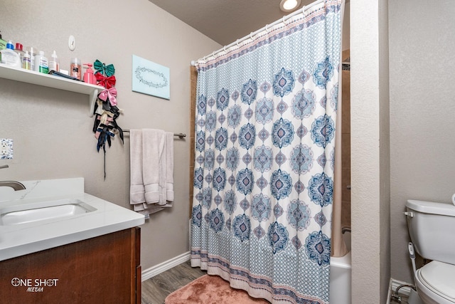 full bathroom with toilet, shower / bath combination with curtain, hardwood / wood-style flooring, and vanity