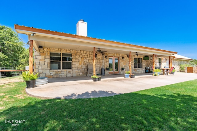 back of property featuring ceiling fan, a patio area, and a yard