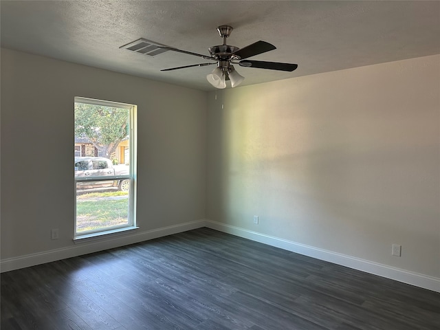 unfurnished room featuring a textured ceiling, plenty of natural light, dark wood-type flooring, and ceiling fan