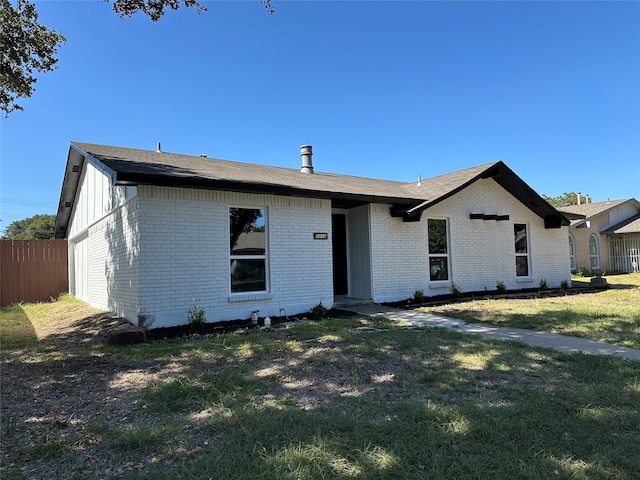 ranch-style home with a front lawn