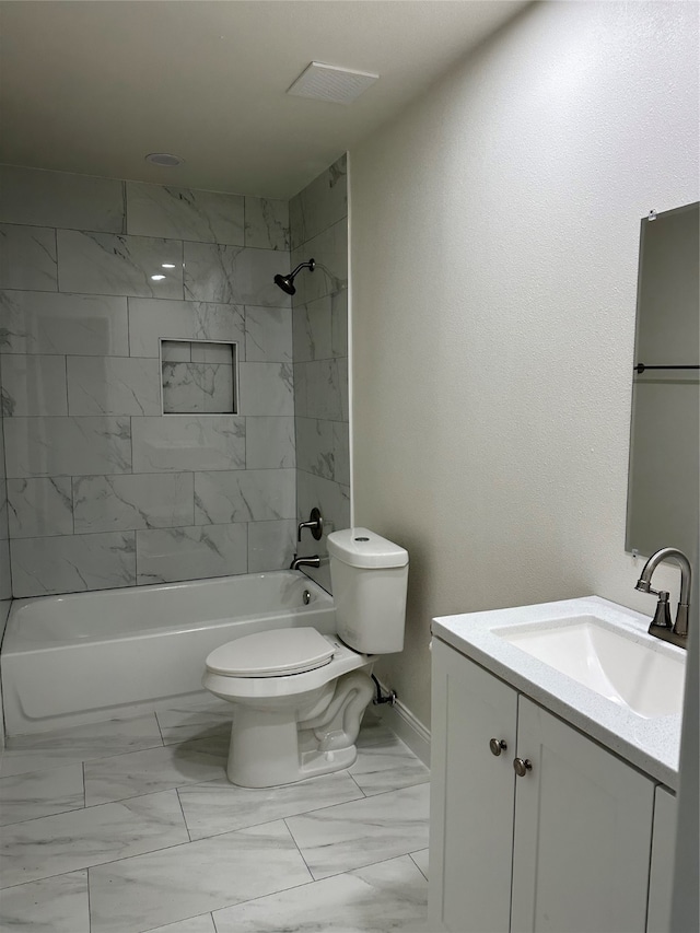 full bathroom with toilet, tiled shower / bath, vanity, and tile patterned flooring