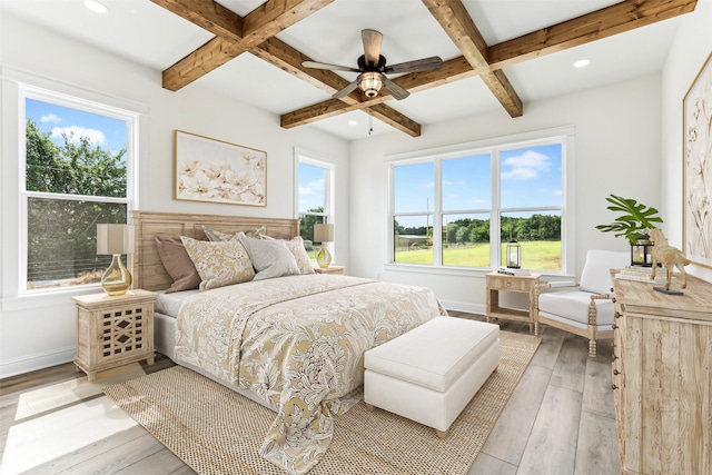 bedroom with ceiling fan, light hardwood / wood-style floors, and multiple windows