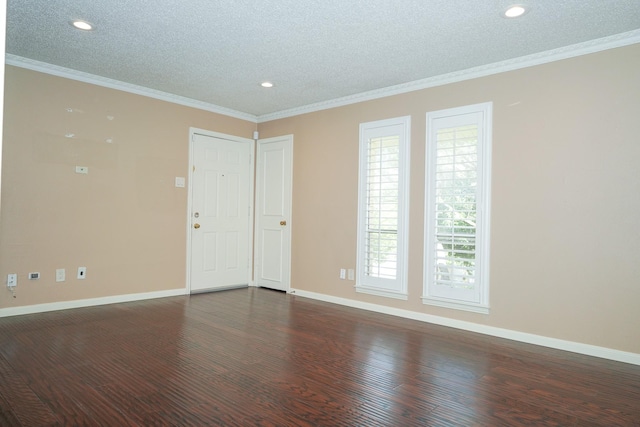 spare room featuring a textured ceiling, dark hardwood / wood-style floors, and crown molding