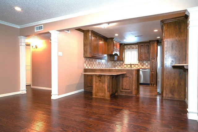 kitchen featuring backsplash, decorative columns, stainless steel appliances, ornamental molding, and kitchen peninsula