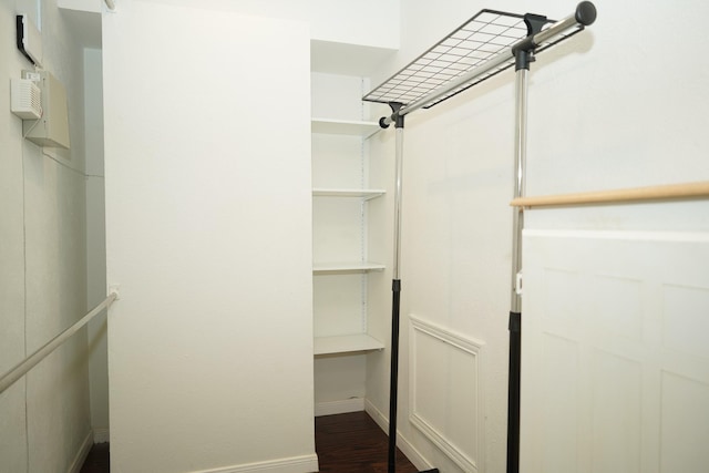 spacious closet featuring dark hardwood / wood-style floors