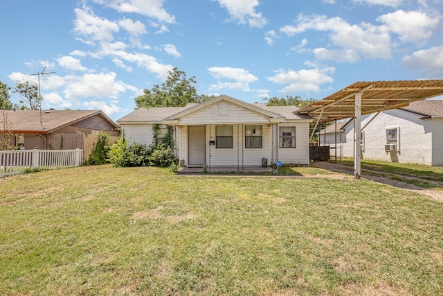 rear view of property featuring a porch and a yard