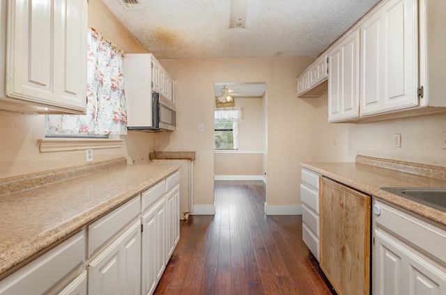 kitchen with dark hardwood / wood-style flooring, white cabinets, a textured ceiling, and ceiling fan