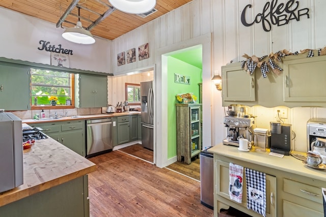 kitchen featuring wood ceiling, dark wood-type flooring, appliances with stainless steel finishes, butcher block counters, and green cabinetry