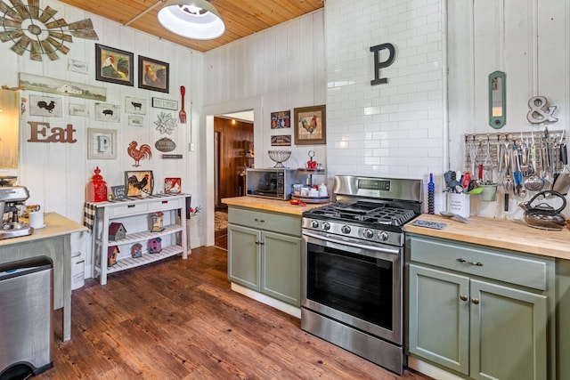 kitchen with stainless steel gas range oven, dark hardwood / wood-style floors, backsplash, and butcher block countertops