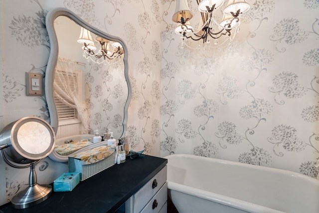 bathroom featuring vanity, a bath, and a notable chandelier