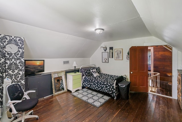 bedroom featuring hardwood / wood-style floors and vaulted ceiling