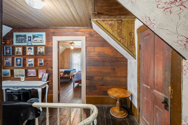 interior space featuring hardwood / wood-style flooring, wooden ceiling, and wood walls