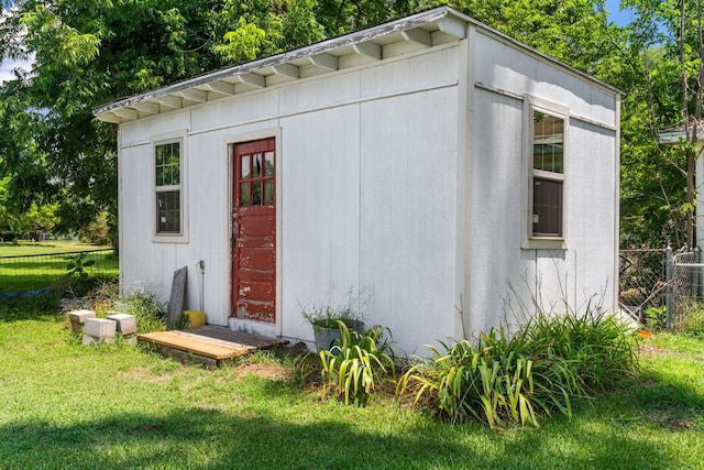 view of outbuilding featuring a lawn