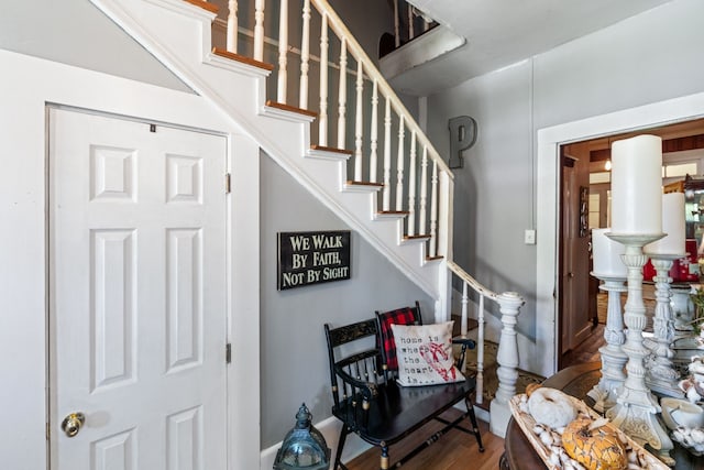 stairs featuring wood-type flooring