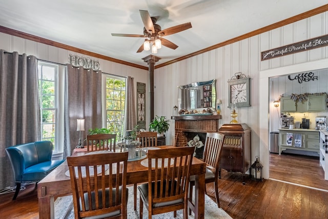 dining room featuring crown molding, dark hardwood / wood-style floors, a wood stove, and ceiling fan