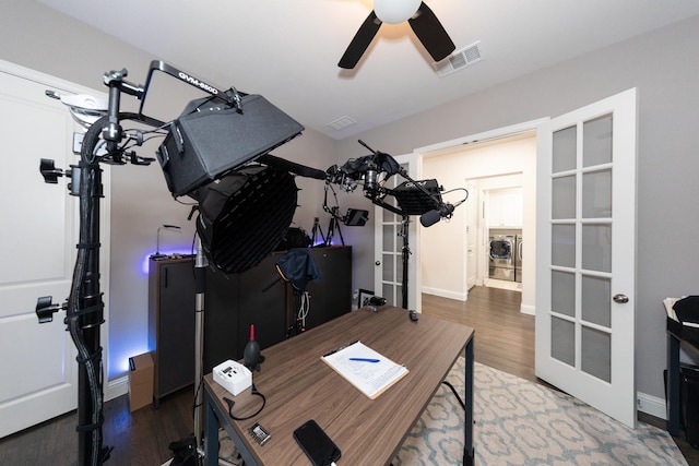 office space featuring washer / dryer, dark hardwood / wood-style floors, and ceiling fan