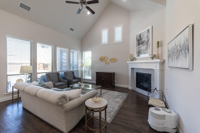 living room featuring ceiling fan, high vaulted ceiling, a fireplace, and dark hardwood / wood-style flooring