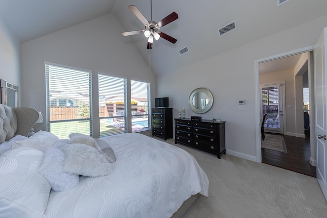 carpeted bedroom with high vaulted ceiling and ceiling fan