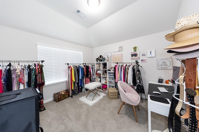 spacious closet featuring vaulted ceiling and light carpet