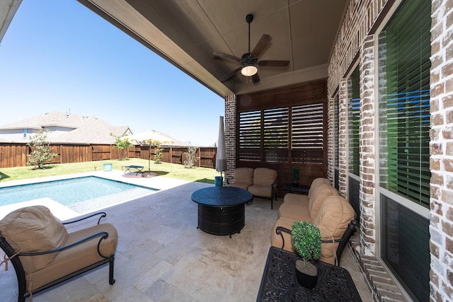 view of swimming pool featuring ceiling fan and a patio area