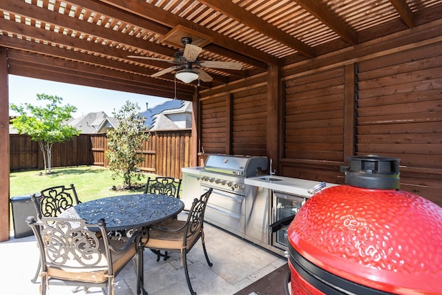 view of patio featuring a pergola, ceiling fan, and an outdoor kitchen