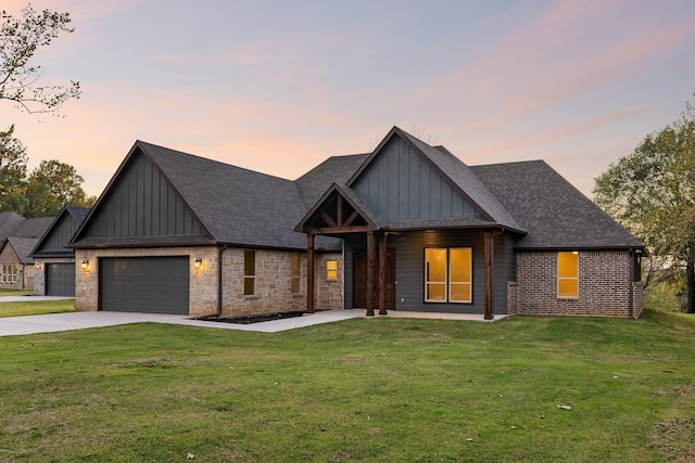 view of front of property featuring a yard and a garage