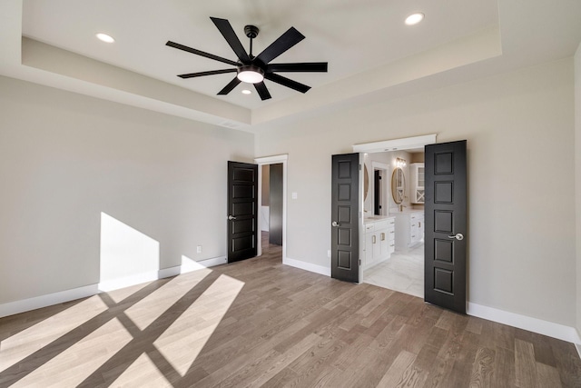 4836 S Theresa, Denison, TX 75020 - unfurnished bedroom with light wood finished floors, recessed lighting, a tray ceiling, and baseboards