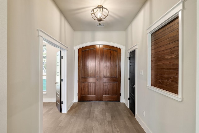 4836 S Theresa, Denison, TX 75020 - entryway with visible vents, baseboards, light wood finished floors, and arched walkways