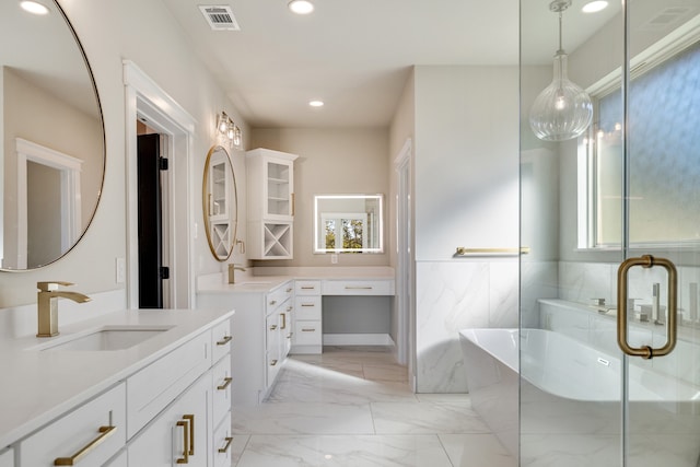 bathroom featuring vanity and independent shower and bath