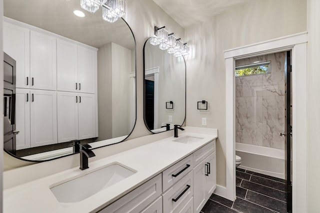 full bathroom with toilet, tiled shower / bath combo, vanity, and tile patterned floors