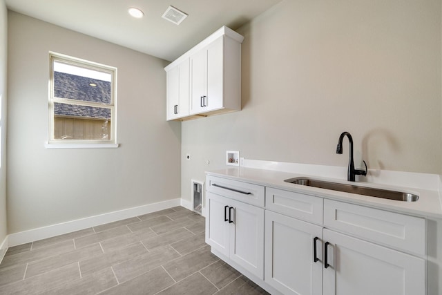4836 S Theresa, Denison, TX 75020 - clothes washing area with hookup for a washing machine, cabinet space, hookup for a gas dryer, a sink, and baseboards