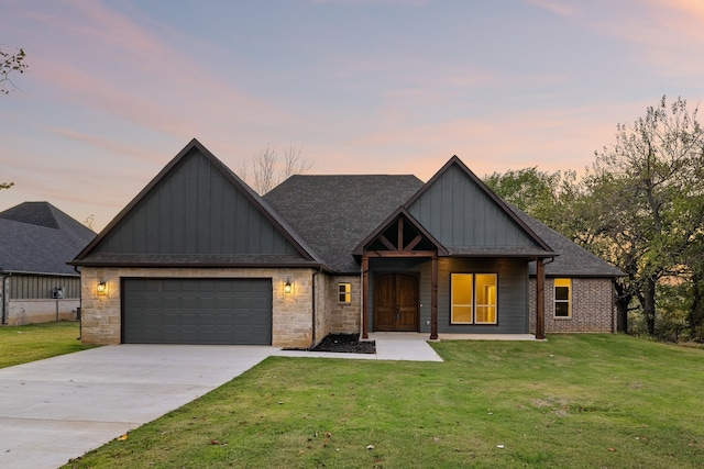 view of front facade with a yard and a garage