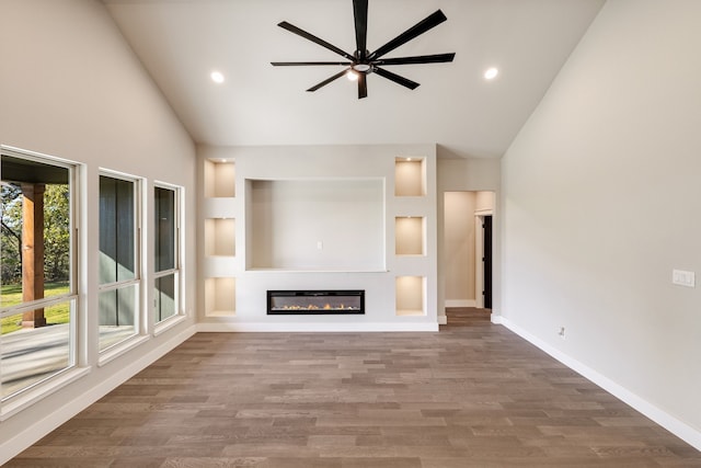 unfurnished living room featuring hardwood / wood-style flooring, high vaulted ceiling, and ceiling fan