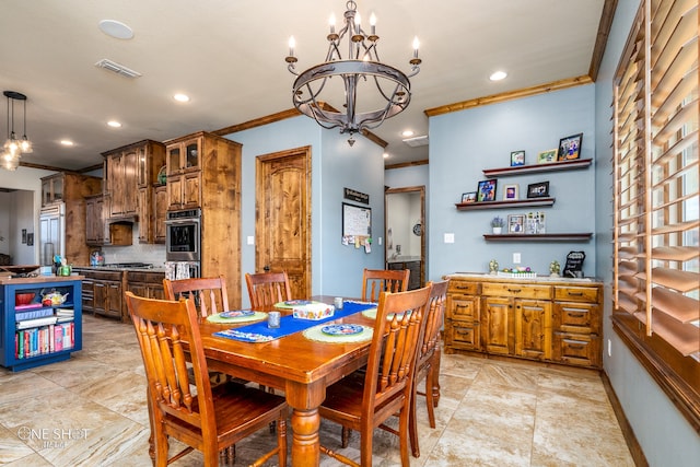 tiled dining area featuring crown molding and an inviting chandelier