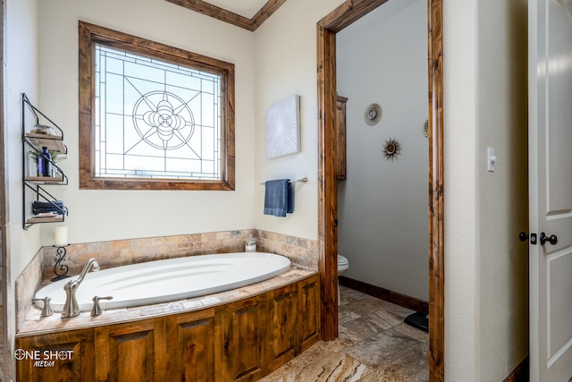 bathroom with a bathing tub, ornamental molding, tile patterned flooring, and toilet