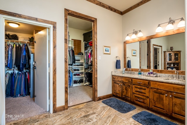 bathroom with dual vanity, tile patterned floors, and crown molding