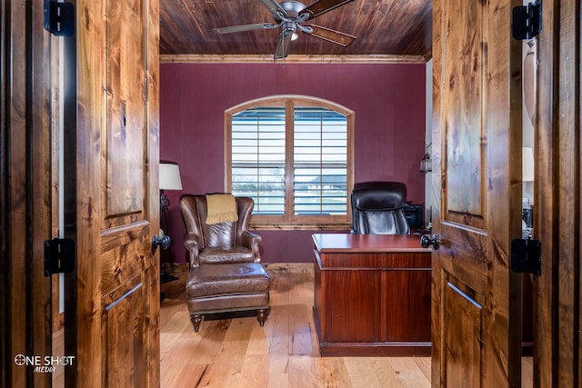 office space featuring crown molding, light hardwood / wood-style flooring, wood ceiling, and ceiling fan