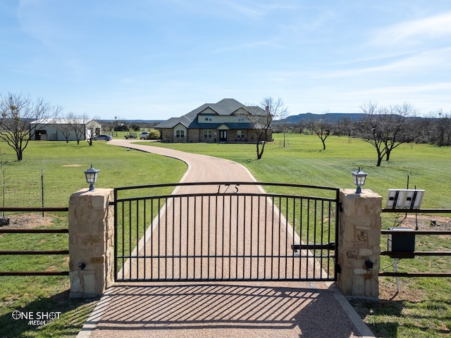 view of gate featuring a yard