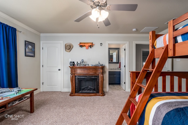 carpeted bedroom featuring ensuite bathroom, ceiling fan, and ornamental molding