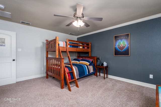 bedroom with a textured ceiling, crown molding, carpet floors, and ceiling fan