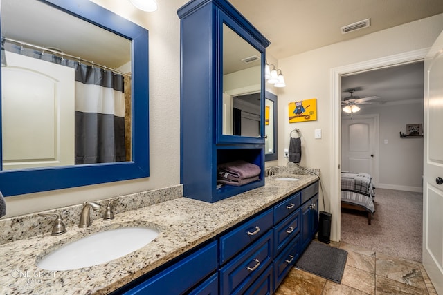 bathroom featuring tile patterned flooring, ceiling fan, and double sink vanity