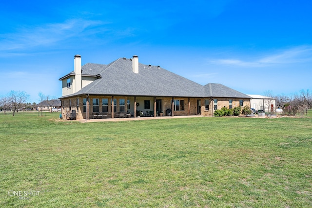 back of property featuring a lawn