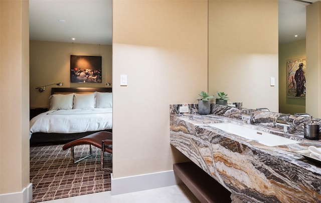 bedroom featuring tile patterned floors and sink