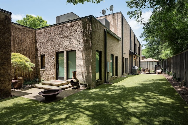 rear view of house with a yard