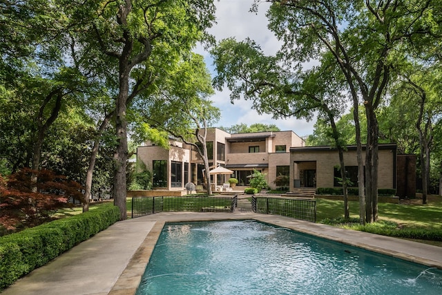 view of pool with pool water feature and a patio