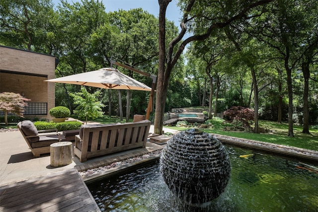 exterior space featuring an outdoor hangout area, a water view, and a pool